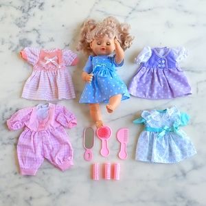 NWOT. Doll and Her Five Color Outfits and Hair Accessories Set.